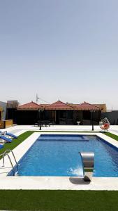 a swimming pool in front of a building at شاليه نايا in Kerak