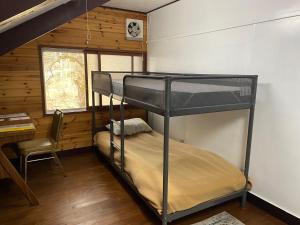 a bedroom with a bunk bed in a cabin at Tanigawa Valley Lodge & Coffee Roastery in Minakami