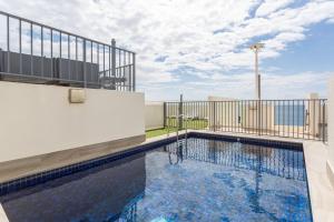 a swimming pool on top of a building at Apartment with Pool Access, a minute to the Beach in Sydney