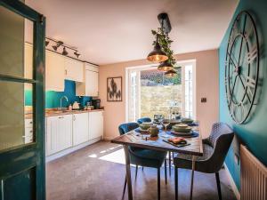 a kitchen and dining room with a table and chairs at Snowdrop Cottage in Bulmer