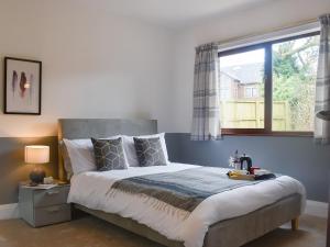 a bedroom with a large bed and a window at The Shieling in Padiham