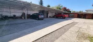 two cars parked in front of a garage at Hostal Prat II in Valdivia