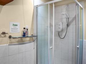 a shower with a glass door in a bathroom at Hopley House in Middlewich