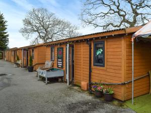 a wooden cabin with a ping pong table in front of it at Hopley House in Middlewich