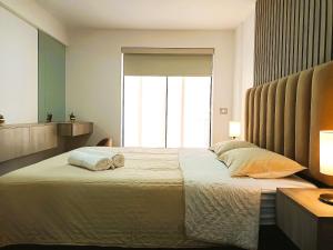 Tempat tidur dalam kamar di R° | Beautiful apartment in San Isidro