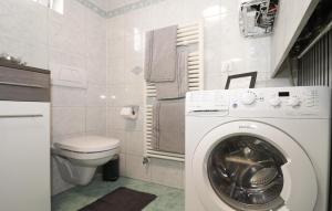 a bathroom with a washing machine and a toilet at Cozy Apartment In Puch Bei Hallein With Kitchen in Puch bei Hallein