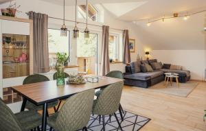 a dining room and living room with a table and chairs at Cozy Apartment In Puch Bei Hallein With Kitchen in Puch bei Hallein