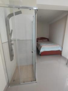 a glass door leading to a bedroom with a bed at Soto Apartamentos in Chiclayo