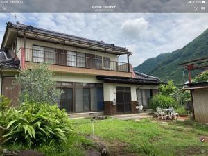 uma casa com uma varanda ao lado em B&B Ladies Only Grape mama Grape room - Vacation STAY 11649 em Koshu