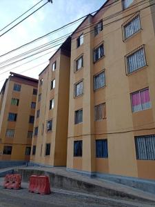 a large building with some red barriers in front of it at Agradable y Económico Apartamento in Santa Fe de Antioquia