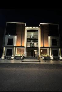 a building at night with a large window at The N&N Executive in Al Madinah