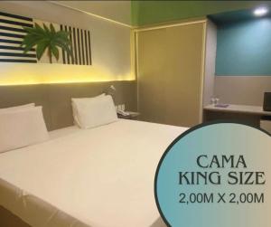 a large white bed in a small room at Hotel na Beira Mar de Fortaleza - Vista Mar in Fortaleza