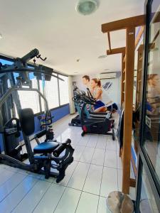 a man and a woman on a treadmill in a gym at Hotel na Beira Mar de Fortaleza - Vista Mar in Fortaleza