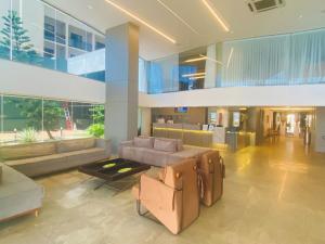 a living room with a couch and chairs in a building at Hotel na Beira Mar de Fortaleza - Vista Mar in Fortaleza