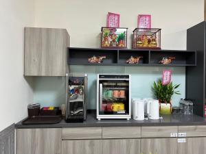 a kitchen with an open refrigerator on a counter at 五星佶民宿 in Jinning