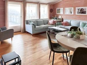 a living room with a couch and a table at Holiday home FINNÅS II 