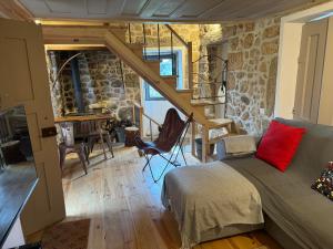 a bedroom with a bed and a table in a room at Cabana da Raposa in Oliveira do Hospital