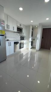 a large kitchen with white cabinets and appliances at Luxurious apartment located in the heart of Panama in Panama City