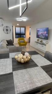 a living room with a couch and a bowl on the floor at Luxurious apartment located in the heart of Panama in Panama City