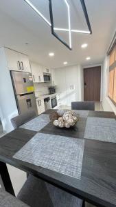 a kitchen with a table with a bowl on it at Luxurious apartment located in the heart of Panama in Panama City