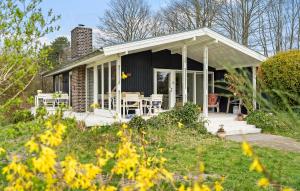 a small house with a porch and a patio at 3 Bedroom Gorgeous Home In Odder in Odder