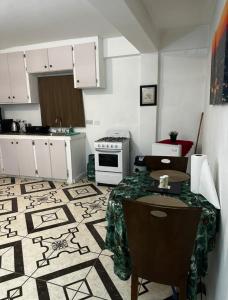 a kitchen with a table and a stove in it at Spacious Home away from Home! 1 Bedroom in Kingstown