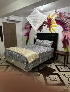a bedroom with a bed with an umbrella on it at Spacious Home away from Home! 1 Bedroom in Kingstown