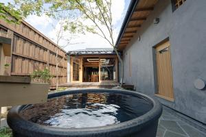 a pond in the courtyard of a house at 海野宿一棟貸し宿 上州屋 Unnojuku Joshuya in Tomi