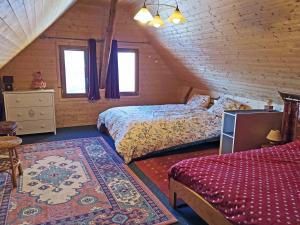 a attic bedroom with two beds and a rug at Chalet Saint-François-Longchamp, 2 pièces, 8 personnes - FR-1-635-139 in Saint-François-Longchamp