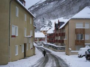 a person walking down a snow covered street at Charmant T2 cabine 3 pers, balcon, parking privé, Luz-Saint-Sauveur - FR-1-402-139 in Esquièze - Sère