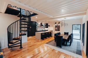 a kitchen and dining room with a spiral staircase in a house at Pacific Bin - Hot Tub, Secluded Forest Getaway in Monroe