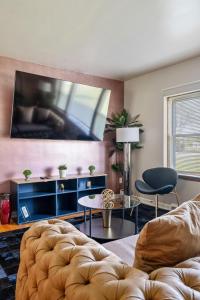 un soggiorno con divano e TV a schermo piatto di Harmony Haven a Westmont