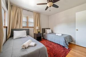 una camera da letto con due letti e un ventilatore a soffitto di Harmony Haven a Westmont