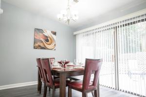 a dining room with a wooden table and chairs at Cozy home, 10 minutes away from downtown in Charlotte