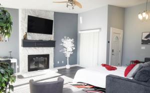 a living room with a bed and a fireplace at Cozy home, 10 minutes away from downtown in Charlotte