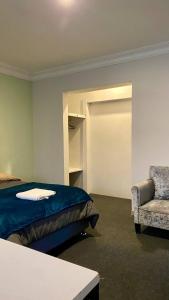 a bedroom with a bed and a chair at Templo de la Luna in Cusco