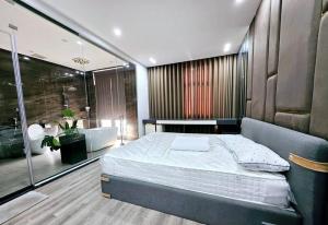 a bedroom with a large bed and a bath tub at Le Luxe Home - Vinhomes Marina tại Lê Chân in Hai Phong