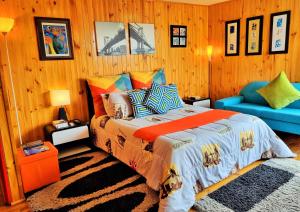 a bedroom with a bed and a blue couch at El Remanso-Guatavita, Casa Campestre Completa in Guatavita