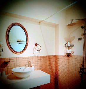 a bathroom with a sink and a mirror at Kokokara B&B in Tainan