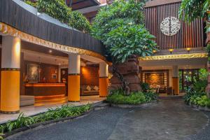 a lobby of a hotel with trees and plants at djabu Seminyak Hotel in Seminyak