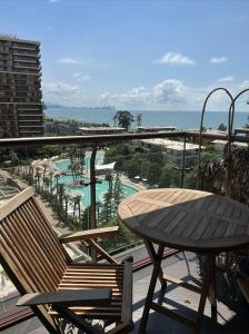 uma mesa e cadeiras numa varanda com o oceano em Cozy apartment with a great view em Chakvi