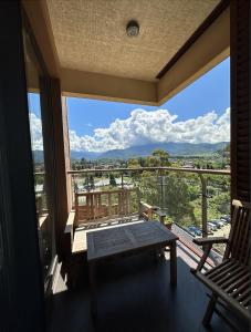 a balcony with a bench and a view of the mountains at Cozy apartment with a great view in Chakvi