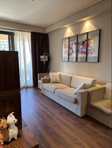 a living room with a couch and a table at Cozy apartment with a great view in Chakvi +41 photos