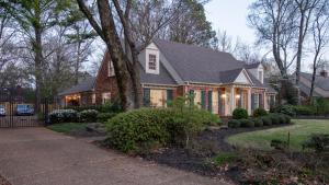 a brick house with a gambrel roof at The Kirby House: King Bed, Hot Tub, Game Rooms, Gym in Memphis