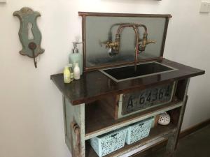 a bathroom sink with a mirror on top of it at Tiny House Farmstay Mount Warning in Eungella