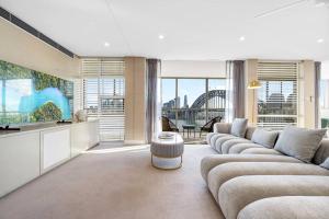 a living room with a couch and a table at Sydney's Landmark Views from Luxury 2Bd Apt in Sydney