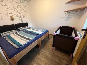 a small bedroom with a bed and a dresser at Apartment Mahlke in Stedar