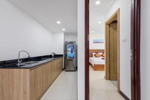 a kitchen with a sink and a refrigerator in a room at Star Hotel in Danang