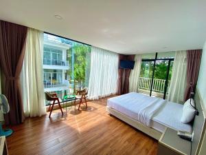 a bedroom with a bed and a large window at Romeo & Juliet Dalat Resort in Da Lat