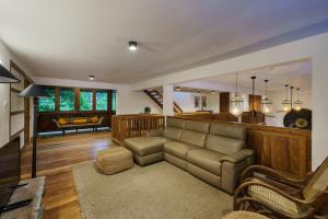 a living room with a couch and a kitchen at Royal Indigo Villa in Unawatuna